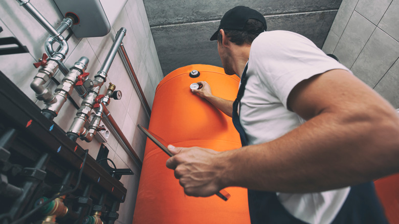 man adjusting water heater 