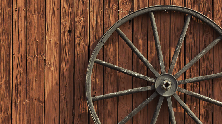 red barn wall with wagon wheel
