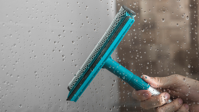 Squeegee drying glass shower door