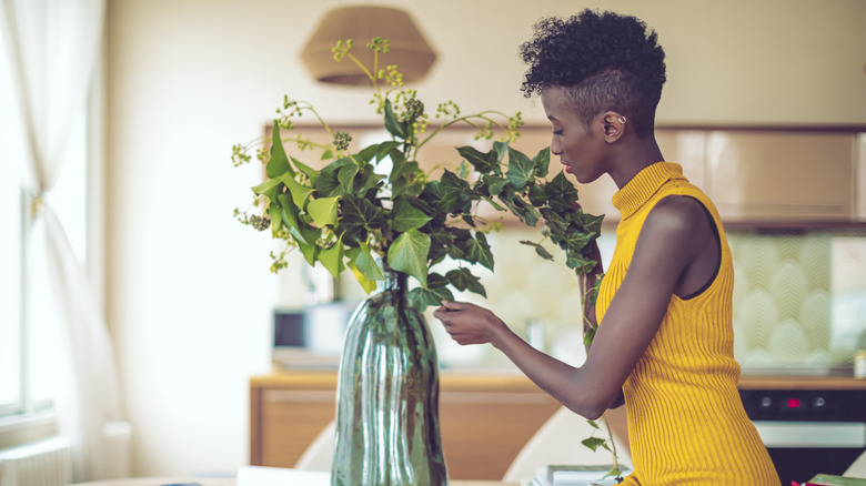 woman with a vase of flowers