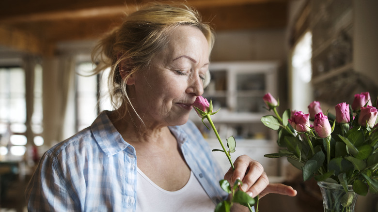A lady smelling the flowers 
