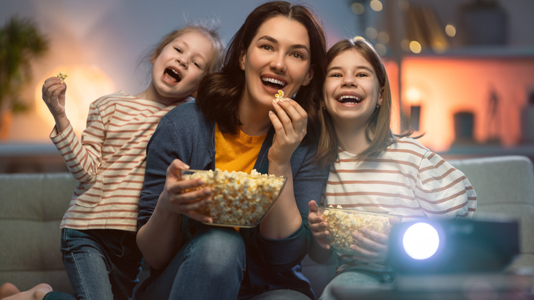 Family watching a projector