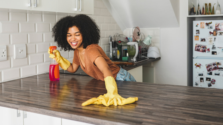 Woman wiping counter with dishtowel