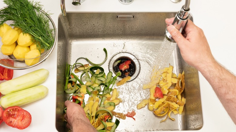 Man using garbage disposal 