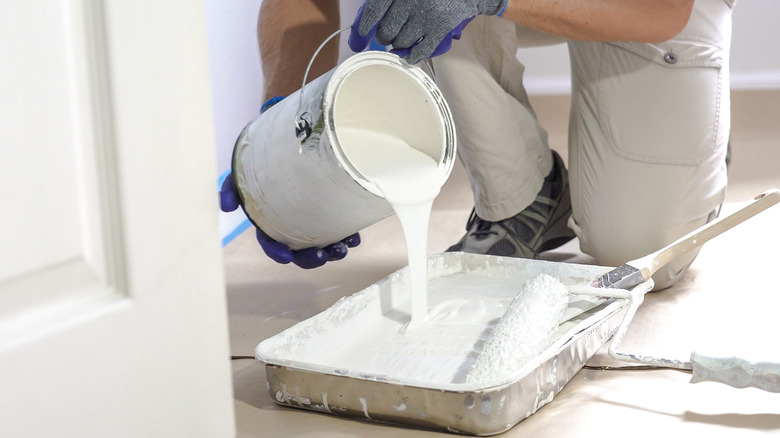 White paint pouring into tray