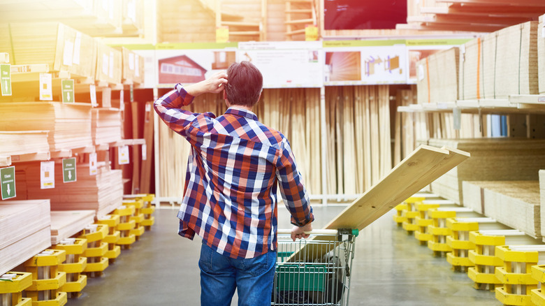 man shopping in lumber section