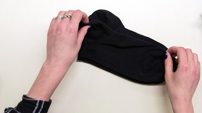 Hands lining up black socks