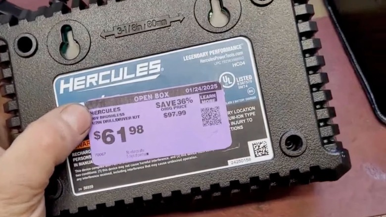 A person holding a purple tag item at Harbor Freight.