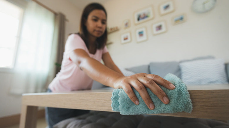 Woman wiping off dust