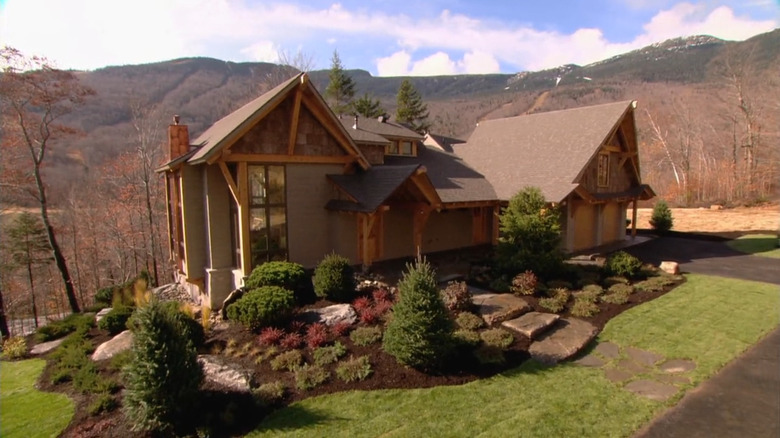 The exterior of the rustic 2011 HGTV Dream House with mountains in the background