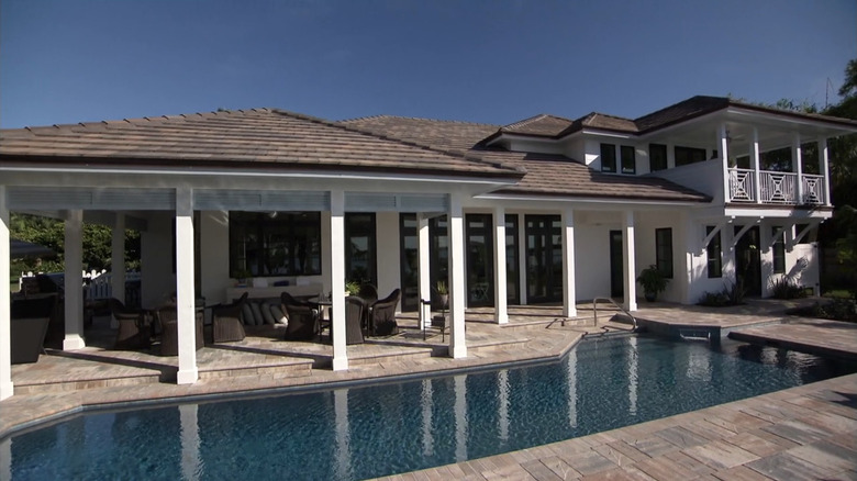 The backyard of the 2016 Dream House featuring a pool and covered patio