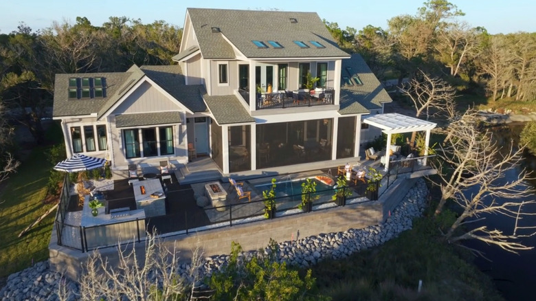 The back of the HGTV Dream House featuring a balcony, pool, and outdoor kitchen