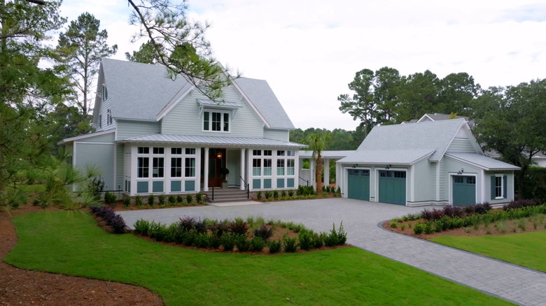 The exterior of the 2025 HGTV Dream House with a greenish blue color scheme