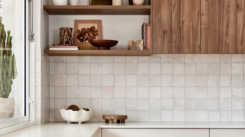 A white kitchen with a zellige tile backsplash.