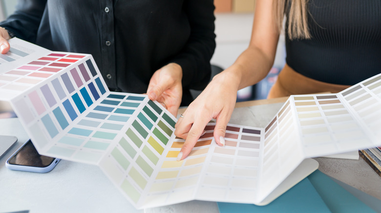 people looking at paint swatches
