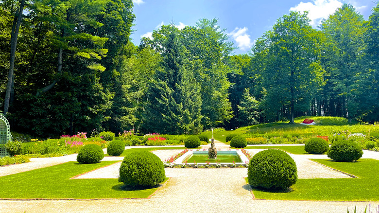 The formal gardens at The Mount including the rectangular fountain, flowers, and trimmed hedges