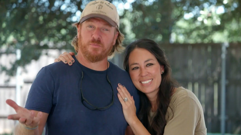 HGTV's Chip and Joanna Gaines standing outside.