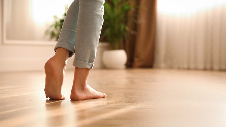 person walking on hardwood floors