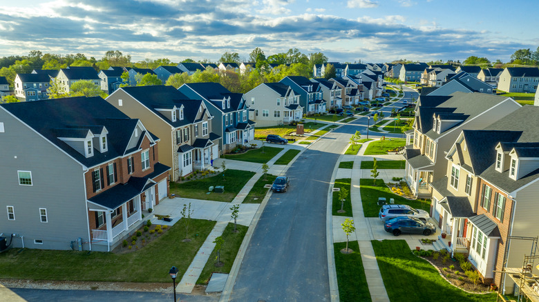 view of houses and curbs