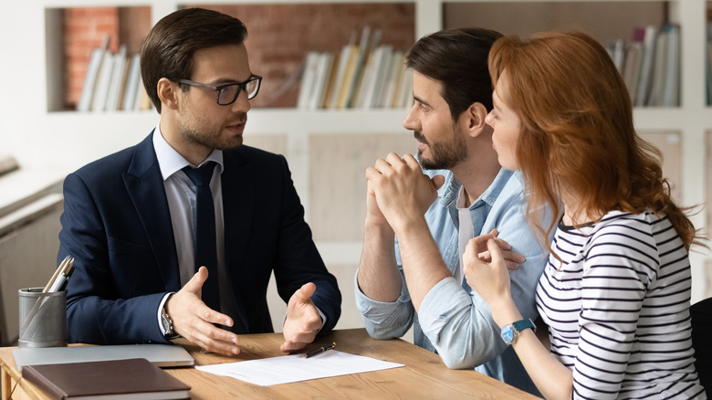 Three people talking at table