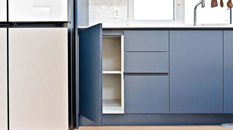 Blue kitchen cabinets ideally spaced to allow homeowners to easily move through the kitchen