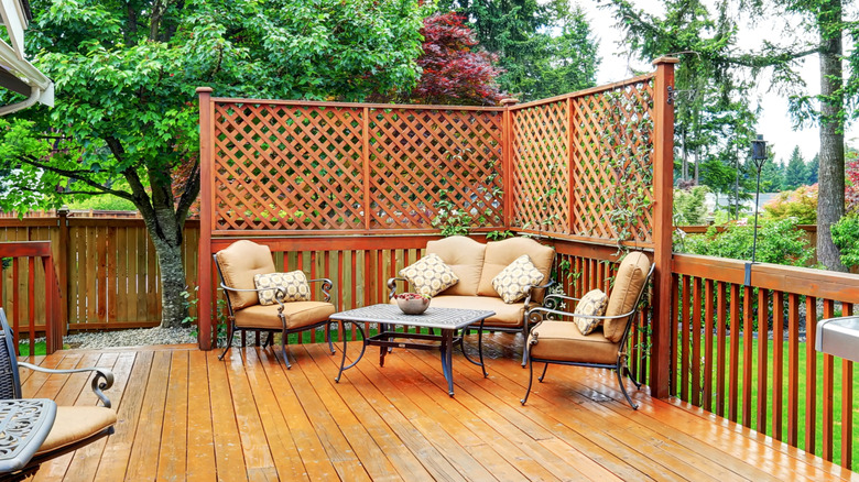 Spacious wooden deck with privacy screen in corner
