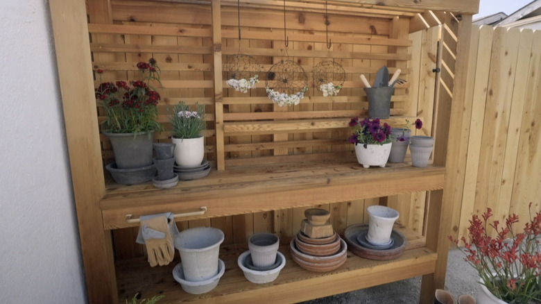 Wooden potting station built into fence