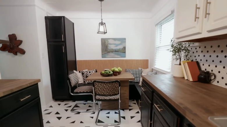 A banquette dining set in a black and white kitchen