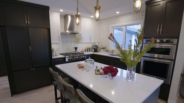 A kitchen and dining room with a paneled refrigerator