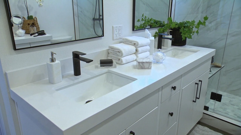 A white modern bathroom with black hardware.