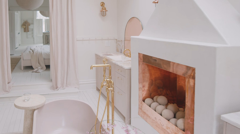 A luxurious bathroom with a copper fireplace.