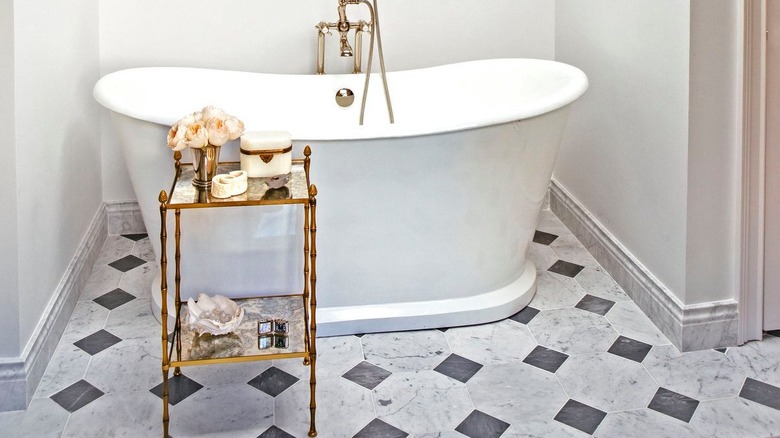Marble tiles with a freestanding tub.