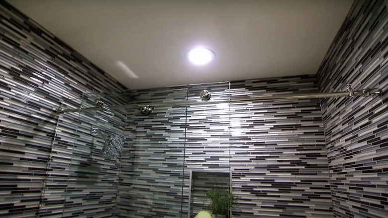 Busy patterned tile around a large shower.
