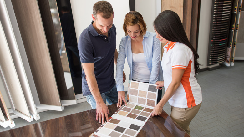 people looking at wood samples