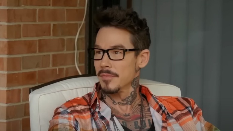 David Bromstad with glasses in orange shirt