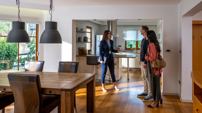 agent showing couple a home