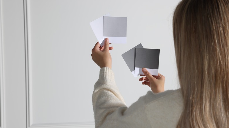 woman looking at gray paint