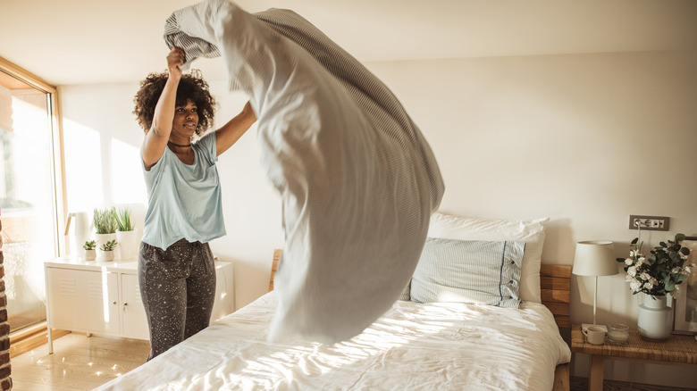 woman making her bed