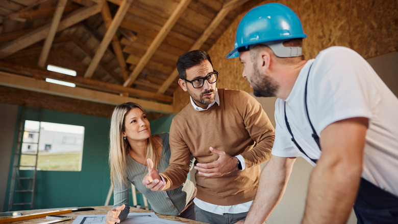 Couple talking with professional about renovations