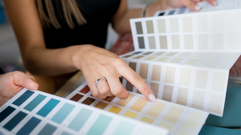 woman selecting paint hue