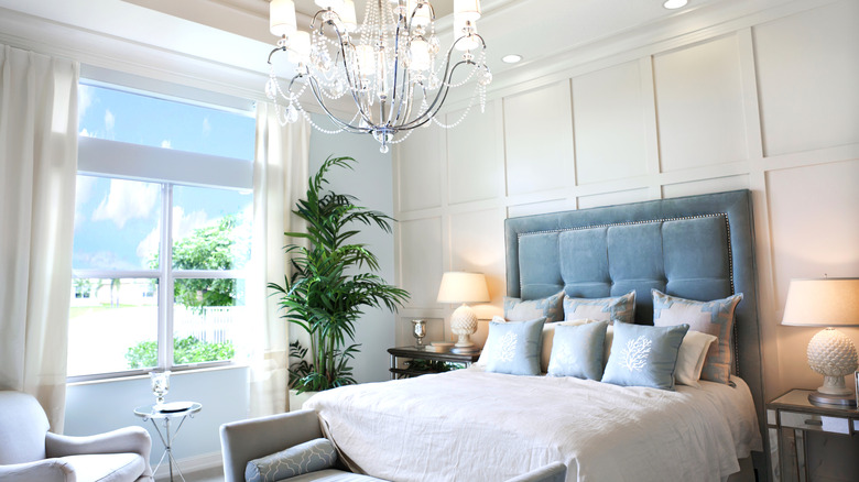 elegant bedroom with tall ceilings and a tall tufted headboard
