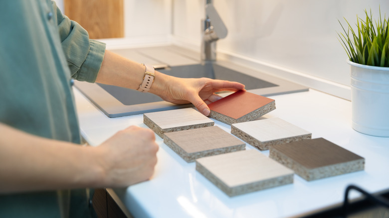 Woman comparing countertop materials