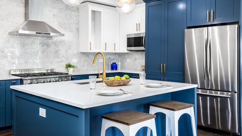 Blue cabinets with white island