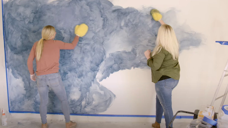 women creating wall mural