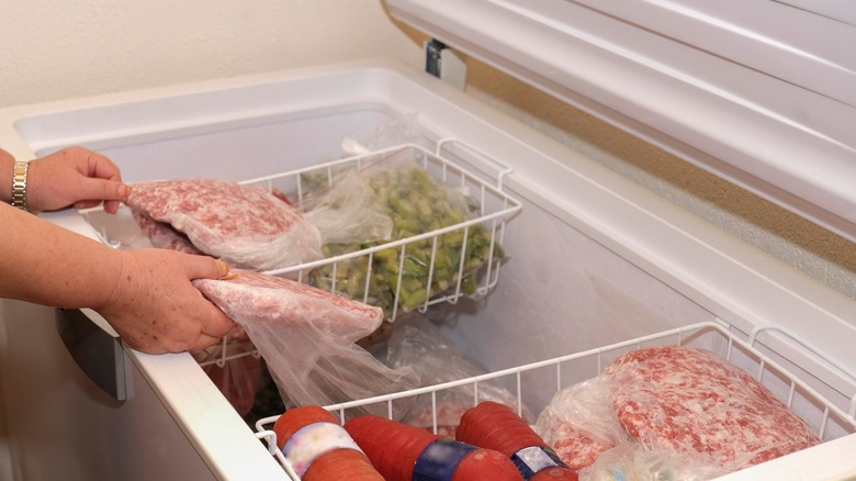 Open freezer chest with food