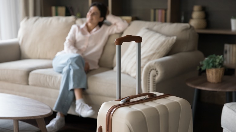 Woman relaxing in guest room