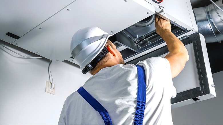 Professional installing ventilation system