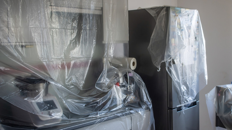 kitchen draped in plastic sheeting