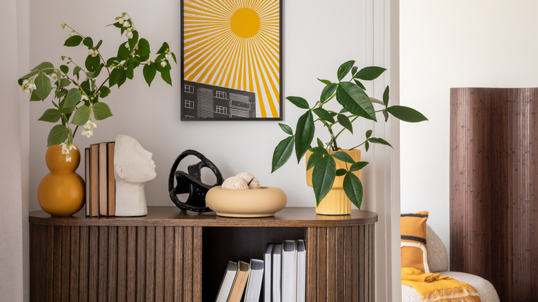 Cabinet with layered decor in wood and plants
