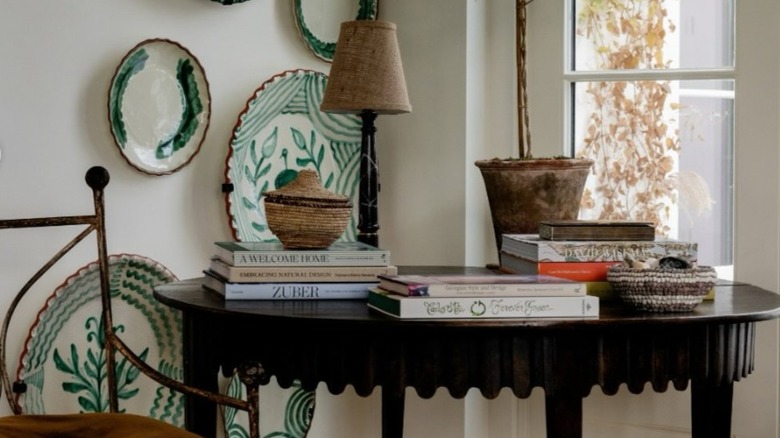 corner in home with chair, end table, and decorative plates